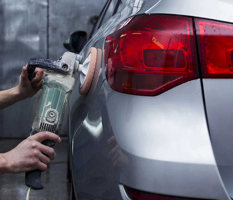 silver car is polishing in the garage